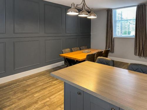 a meeting room with a wooden table and chairs at The Old School House in Eggleston