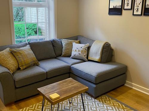 a living room with a couch and a coffee table at Lantern Cottage in Lyndhurst