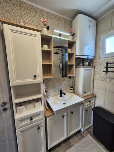 a kitchen with a sink and a refrigerator at Apartman Prošperino in Vis