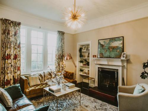 a living room with a couch and a fireplace at Fern Forest House- Uk31047 in Portpatrick