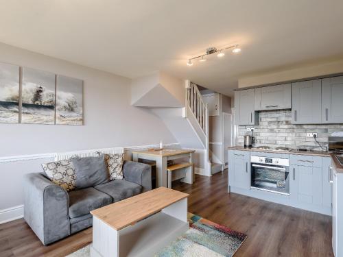 a living room with a couch and a table at Cottage 2 - Uk38222 in Ashby cum Fenby