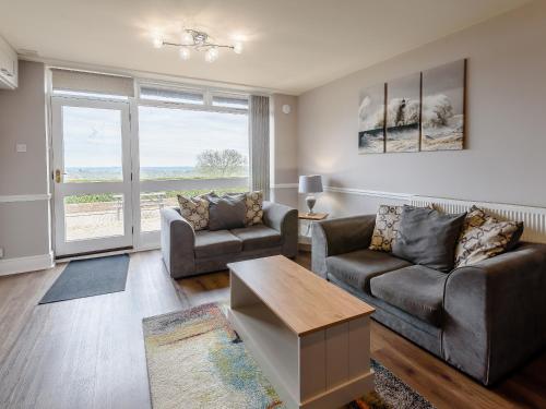 a living room with two couches and a table at Cottage 2 - Uk38222 in Ashby cum Fenby