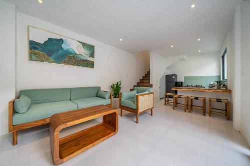 a living room with a couch and a table at Nyma Villa in Seminyak
