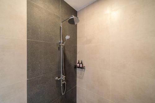 a shower with a glass door in a bathroom at Nyma Villa in Seminyak