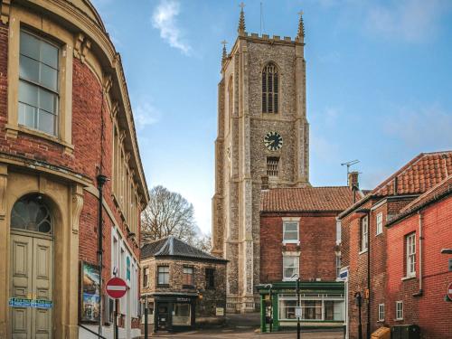 a church with a clock tower in a city at Jacobs Folly-Qu7115 in Melton Constable