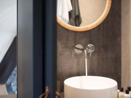 a bathroom with a white sink and a mirror at Gwenllian in Machynlleth
