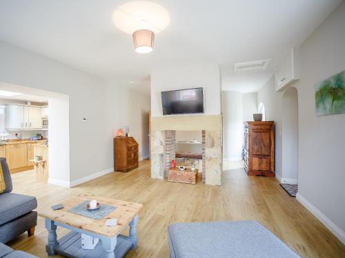 a living room with a couch and a table at Glebelands Lodge in Alnwick