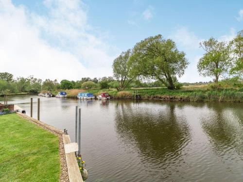 a view of a river with boats in it at Riversdelle in Beccles