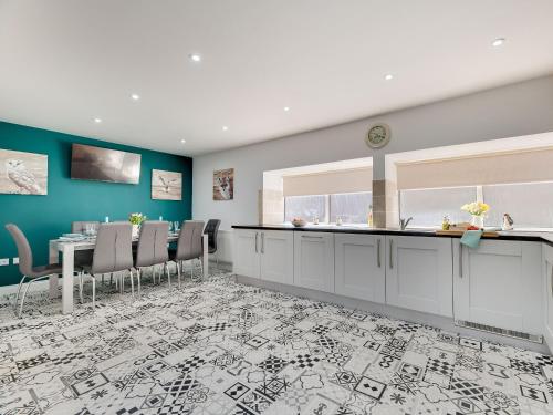 a kitchen and dining room with a table and chairs at The Old Forge - Muz in Wooler