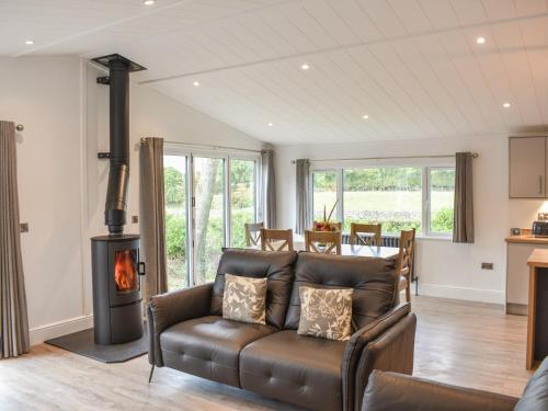 a living room with a couch and a stove at The Oaks in Great Strickland