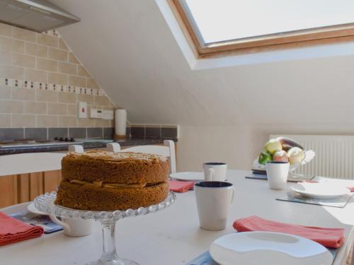 a cake sitting on a table in a kitchen at The Loft - Uk34070 in Lynton