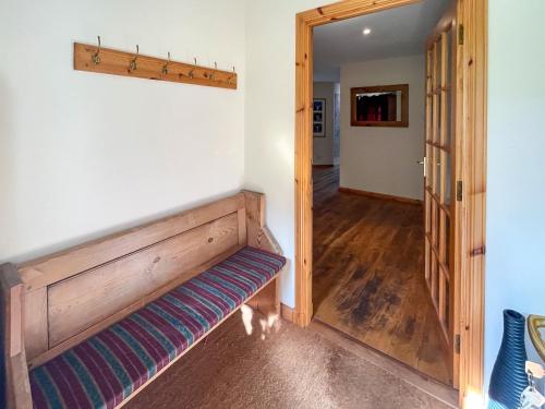 a hallway with a wooden bench in a room at River View in Dalwhinnie