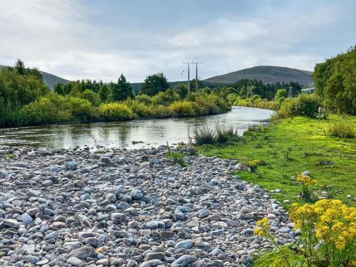 a river with a bunch of rocks on the side at River View in Dalwhinnie