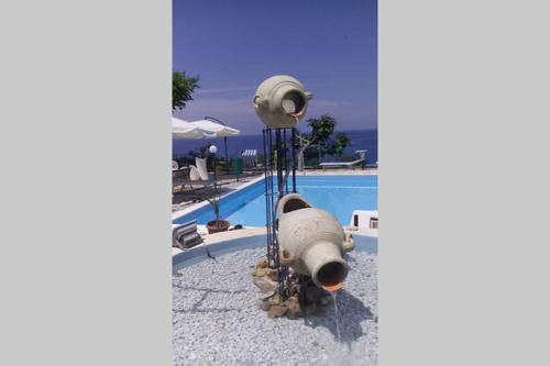 a missile sitting next to a swimming pool at Hotel Piccolo Mondo in Acquappesa