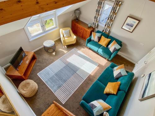 an overhead view of a living room with a couch and chairs at Townhouse - Uk48078 in Kirkwall