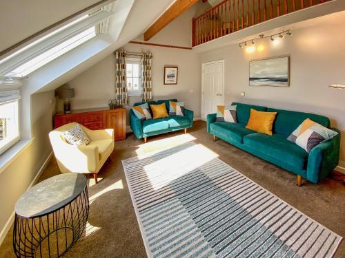 a living room with a green couch and chairs at Townhouse - Uk48078 in Kirkwall