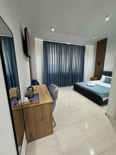 a bedroom with a bed and a desk in a room at Hotel Majestic in Struga