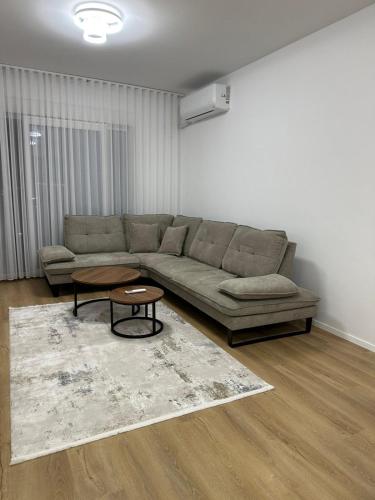 a living room with a couch and a coffee table at Skyline Apartment 3 in Peje