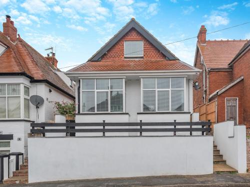 a house with a white fence in front of it at Sea Breeze House in Skegness