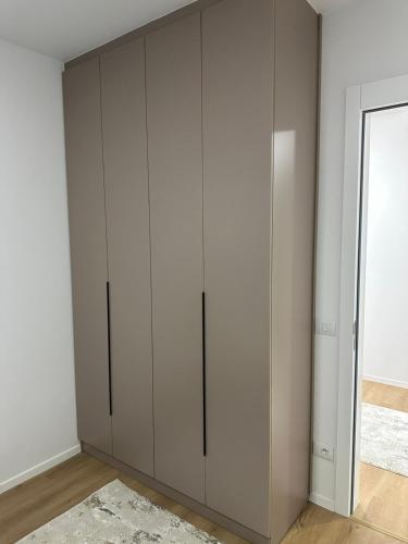 a closet with white cabinets in a room at Skyline Apartment 3 in Peje