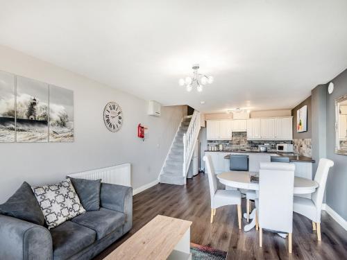 a living room and kitchen with a couch and a table at Cottage 5 - Uk38221 in Ashby cum Fenby