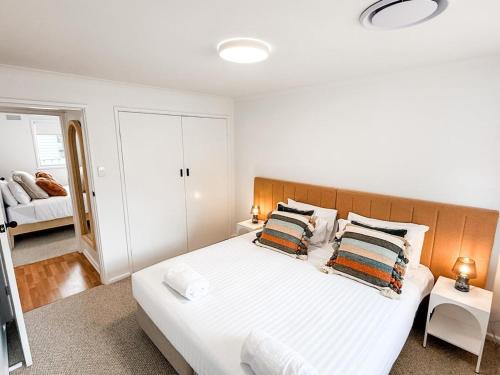 a bedroom with a large white bed with two pillows at Halloran 2 in Wagga Wagga