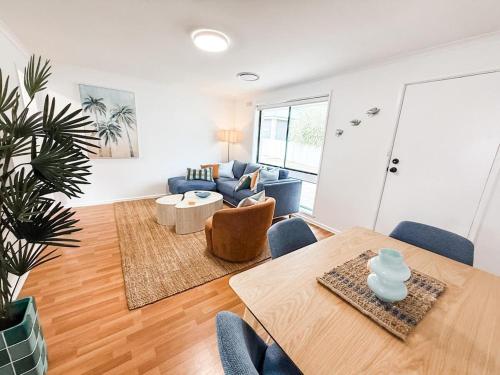 a living room with a table and a couch at Halloran 2 in Wagga Wagga