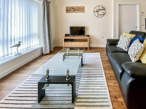 a living room with a couch and a coffee table at Copinsay - Uk48089 in Kirkwall