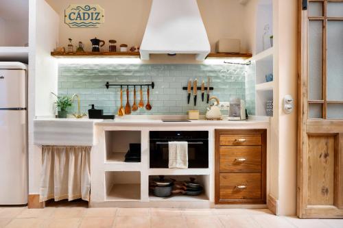a kitchen with a sink and a stove at Mi Andalusia Hotel Experience in Málaga