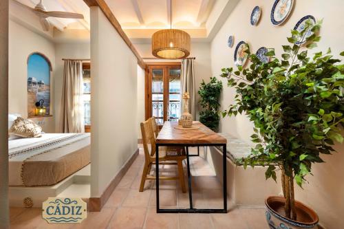 a dining room with a table and a bedroom at Mi Andalusia Hotel Experience in Málaga