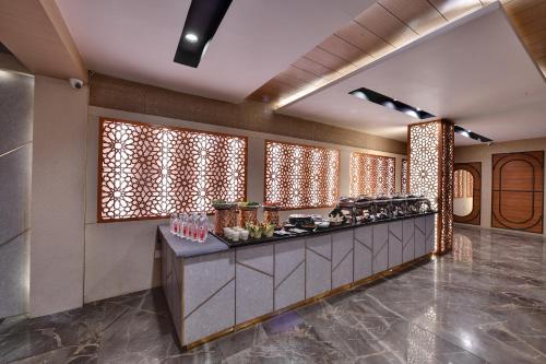 a lobby with a counter with food on it at RnB Select Walk Inn Lucknow in Lucknow