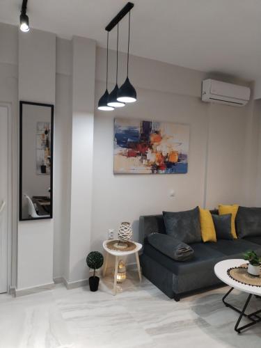 a living room with a couch and a table at Our No1 apartment Paralia in Paralia Katerinis