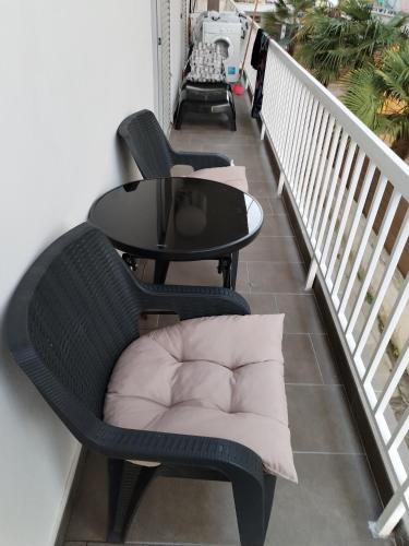 a balcony with two chairs and a table at Our No1 apartment Paralia in Paralia Katerinis