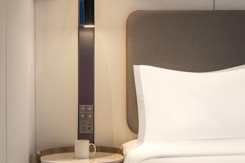 Ένα ή περισσότερα κρεβάτια σε δωμάτιο στο Holiday Inn Express Yibin Xuzhou by IHG