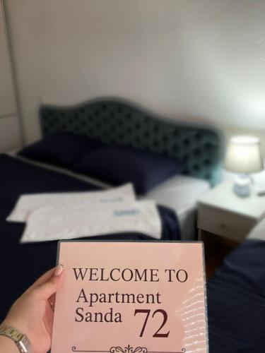 a person holding a sign that says welcome to appointment samaria at Apartment Sanda 72 in Gevgelija