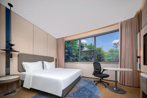 Ένα ή περισσότερα κρεβάτια σε δωμάτιο στο Holiday Inn Express Yibin Xuzhou by IHG