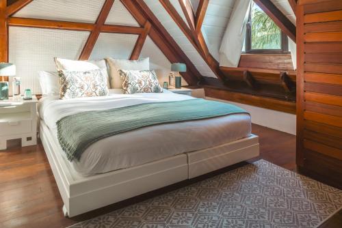 a bedroom with a bed and a desk and a window at Villa Matahari by muse villas in Rivière Noire