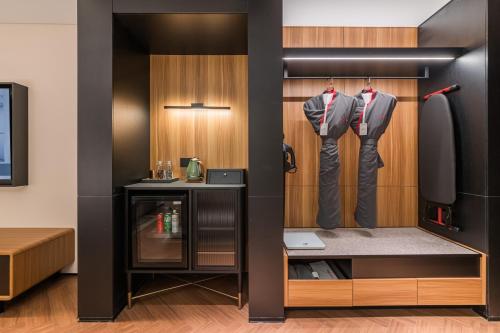a room with a closet with shirts and pants at IntercityHotel Zhuhai Xiangzhounanping with Free Mini Bar in Zhuhai
