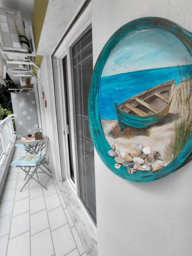 a painting of a boat on the side of a house at Simply Like Home in Kavala