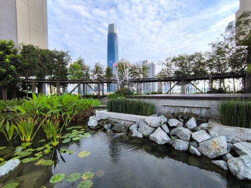 a koi pond in a city with a skyscraper at Axon Residence Near Fehrenheit Bukit Bintang in Kuala Lumpur