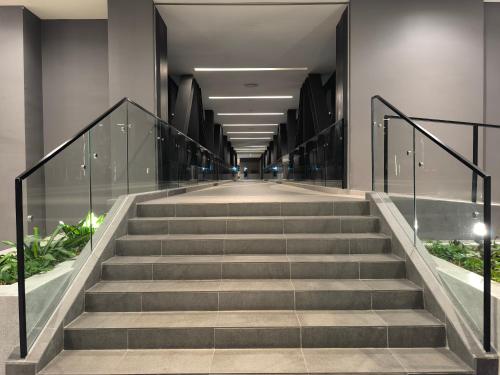 a long hallway with stairs in a building at Axon Residence Near Fehrenheit Bukit Bintang in Kuala Lumpur