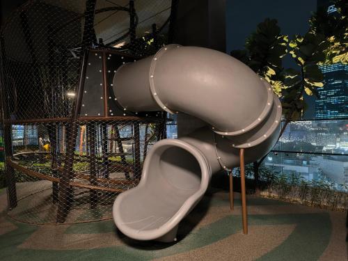 a slide in front of a roller coaster at Axon Residence Near Fehrenheit Bukit Bintang in Kuala Lumpur