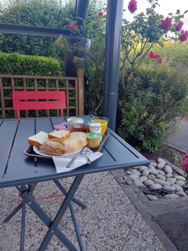 a picnic table with a plate of food on it at Premiere Classe Arras - Tilloy Les Mofflaine in Tilloy-lès-Mofflaines