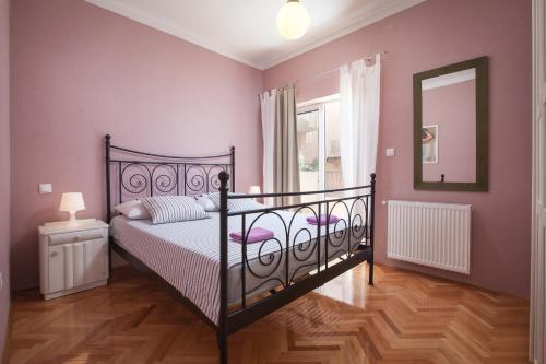 a bedroom with a black bed and a mirror at WATERFRONT Roko 2 in Podgora