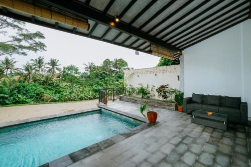 a swimming pool in the backyard of a house at Uma Jala Villa Ubud in Ubud