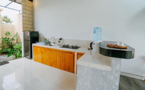 a kitchen with a sink and a counter top at Uma Jala Villa Ubud in Ubud
