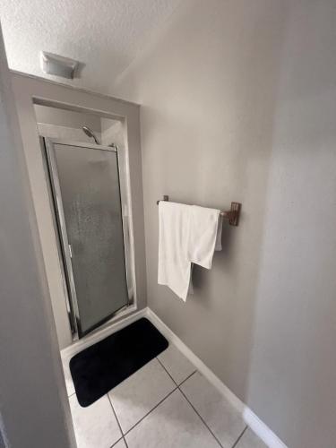 a bathroom with a shower and a towel on a rack at Spacious Lake Retreat for Families in Saint Cloud