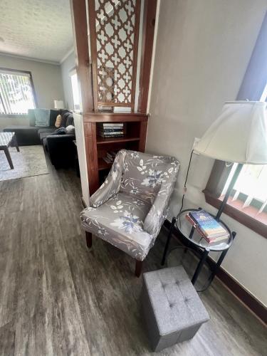 a living room with a chair and a lamp at Spacious Lake Retreat for Families in Saint Cloud