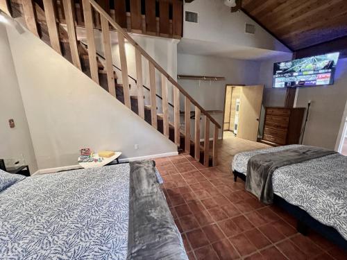 a large room with two beds and a staircase at Spacious Lake Retreat for Families in Saint Cloud