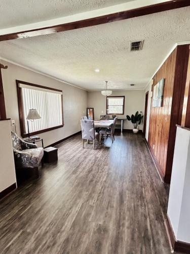 an empty living room with a table and chairs at Spacious Lake Retreat for Families in Saint Cloud